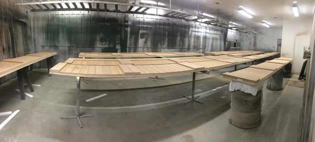 Custom wooden garage doors being prepped for staining by Overhead Door Sioux City