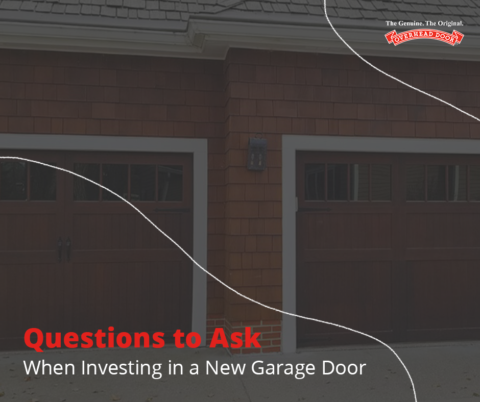 Two men repairing a brown garage door