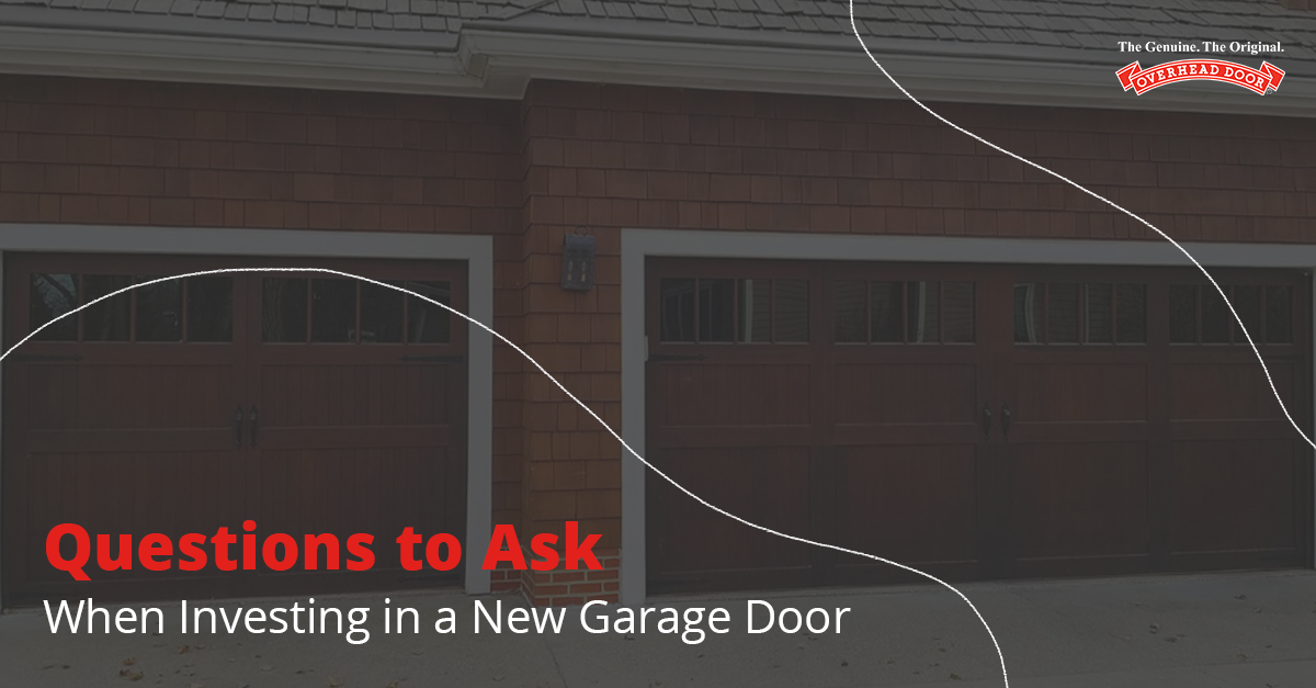 Two men repairing a brown garage door